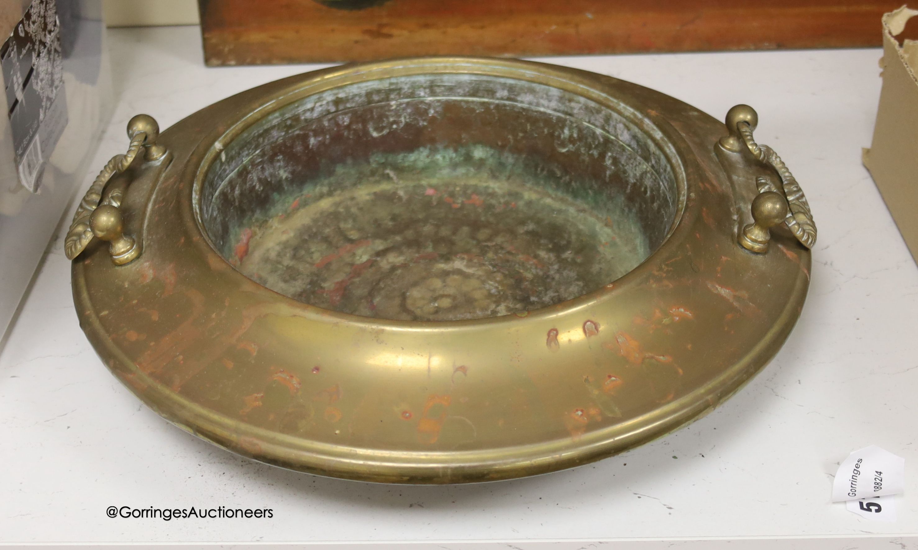 A circular brass two handled bowl, diameter 38cm